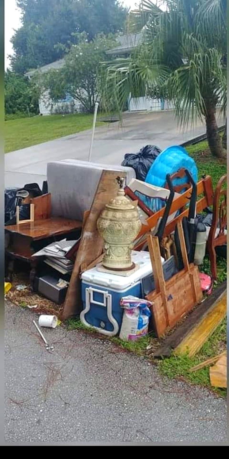 Driveway piled with junk before the haul