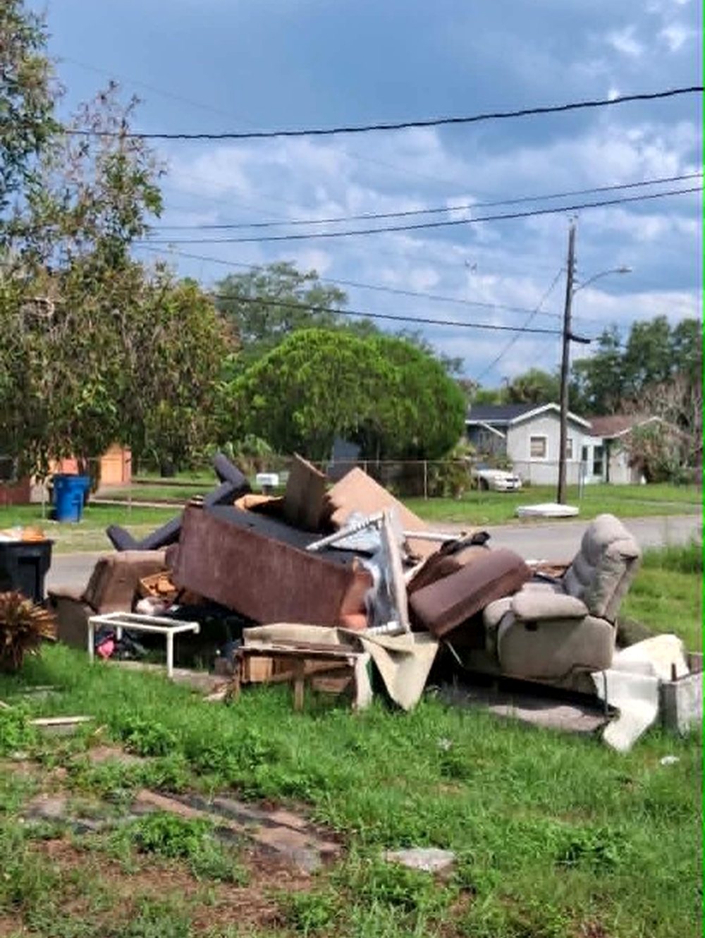 Curbside pile of old furniture waiting for pickup in Brevard