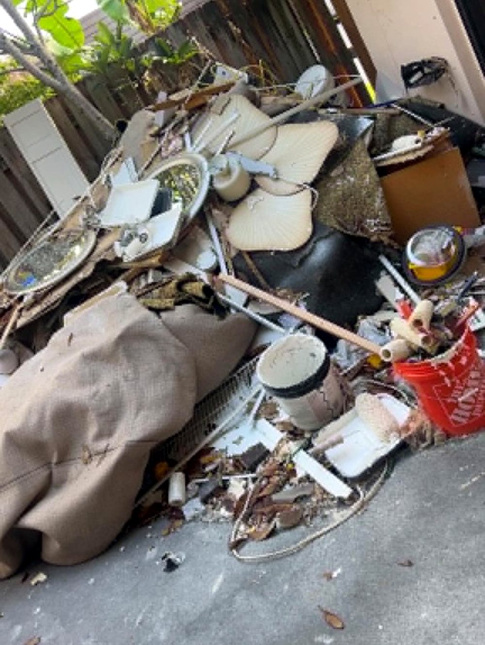 Patio piled with renovation debris before a clean out