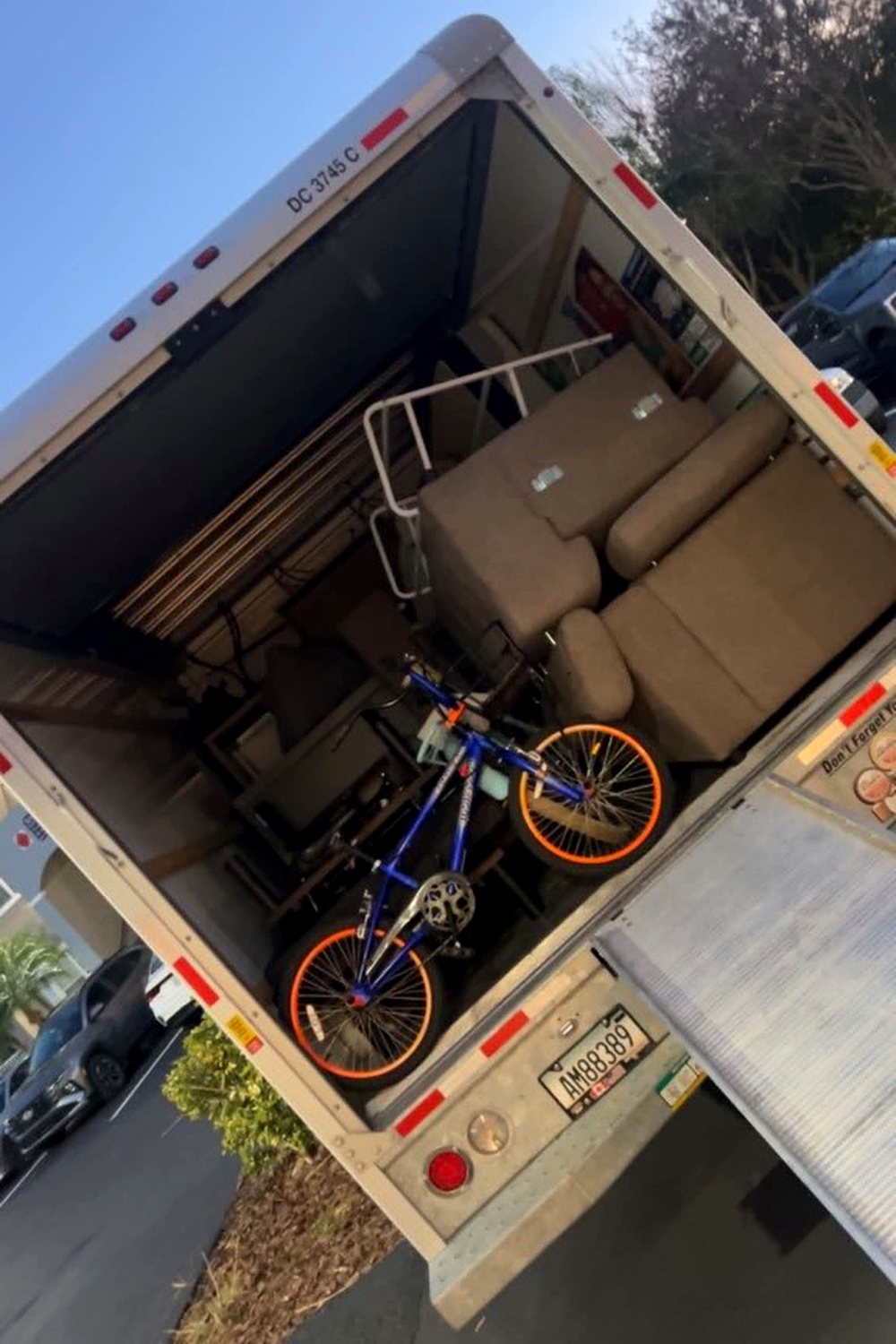 Moving truck loaded with a sectional and a kid's bike